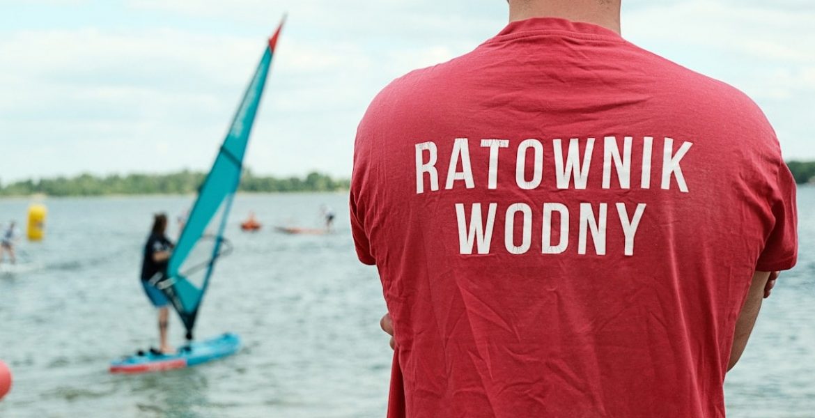 Water rescue lifeguard watching over Pogoria III lake during a summer watersports day in Poland.