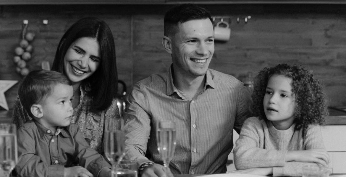 Smiling family enjoying quality time together at dining table in cozy kitchen.