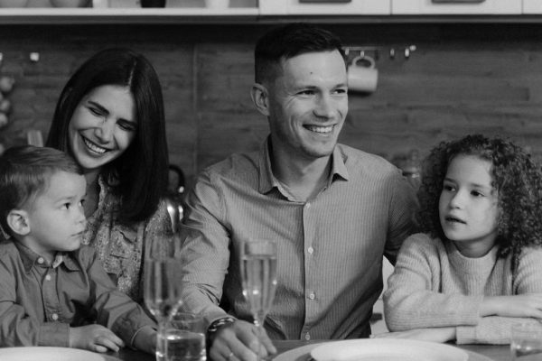 Smiling family enjoying quality time together at dining table in cozy kitchen.